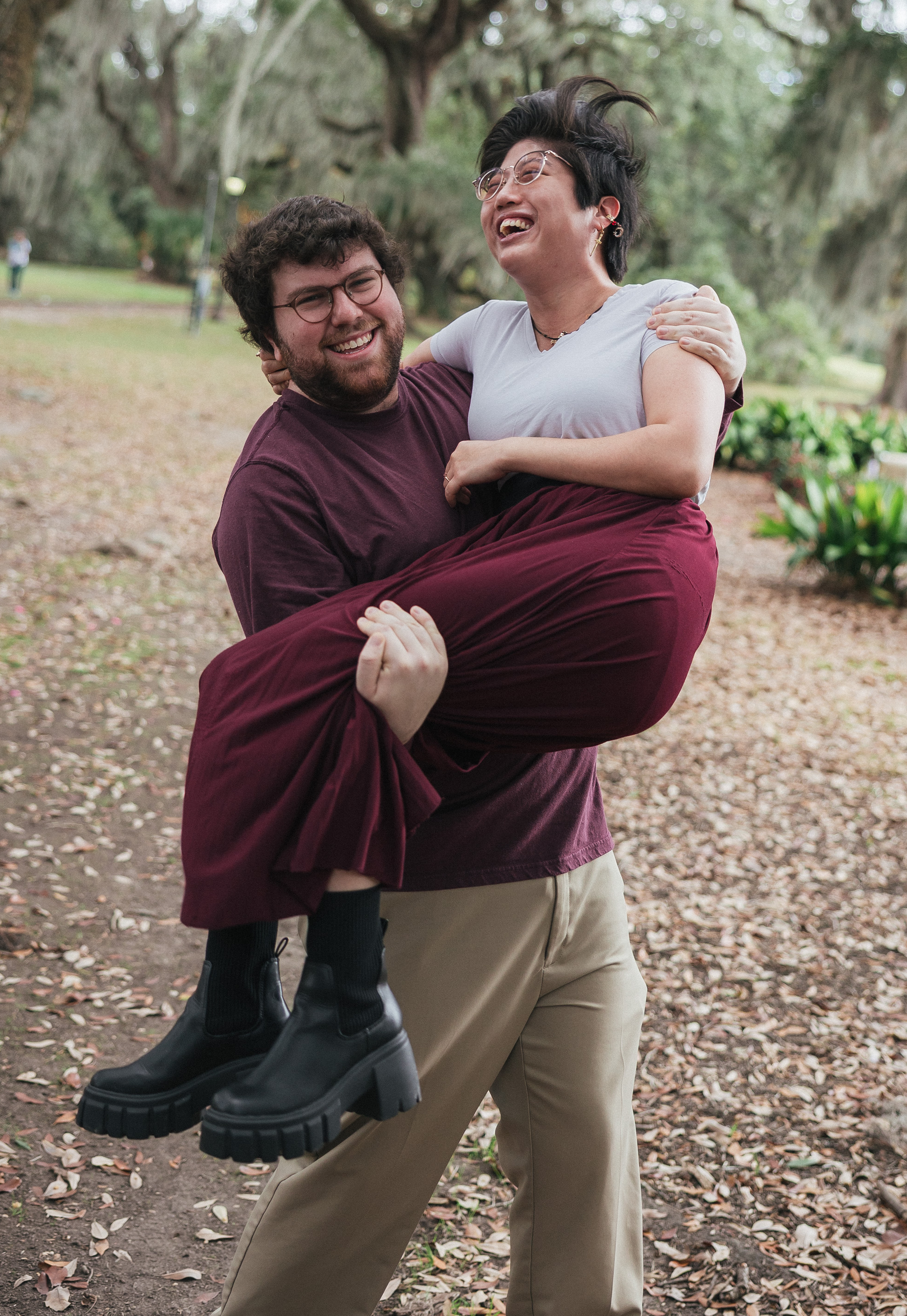 A candid photo of the couple laughing together outdoors